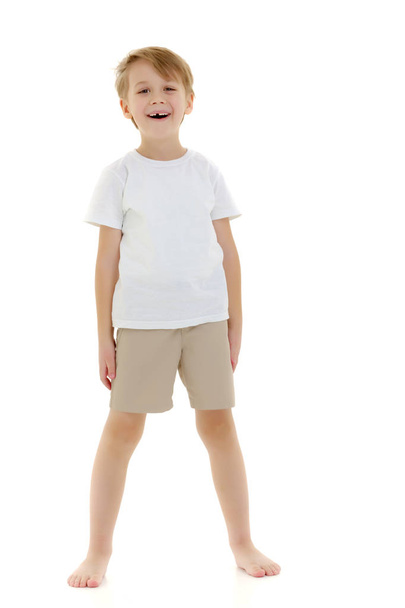 Emotional little boy in a pure white t-shirt. - 写真・画像