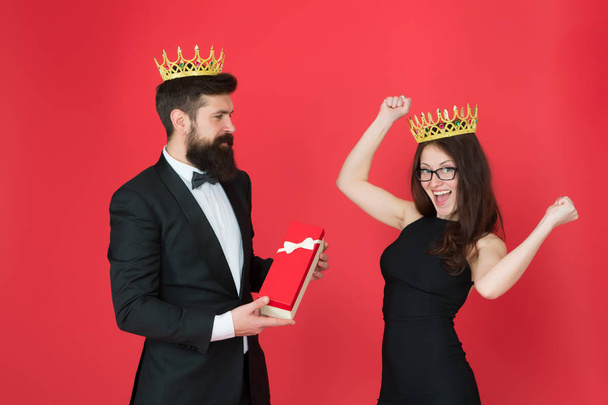 reward. man in tuxedo and sexy woman. Bearded man and happy woman in crown. royal couple in love. date success. fashion look. anniversary party gift. Formal couple. pleasant reward. For you - 写真・画像