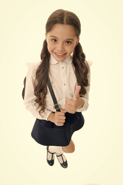 Highly recommend. Schoolgirl shows thumb up gesture, isolated white background. Girl happy smiling recommendation. Child pupil school uniform highly recommend with thumb up gesture. Make right choice - Fotografie, Obrázek