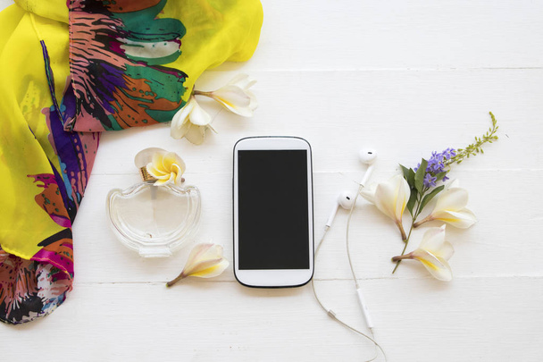 yellow scarf ,mobile phone with perfume accessories of lifestyle woman relax summer and flower frangipani decoration on background white - Foto, Imagem