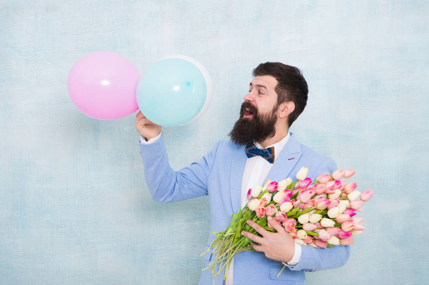Confidence and charisma. Man bearded gentleman suit bow tie hold air balloons and bouquet. Gentleman making romantic surprise for her. Flowers delivery. Gentleman romantic date. Birthday greetings - Zdjęcie, obraz