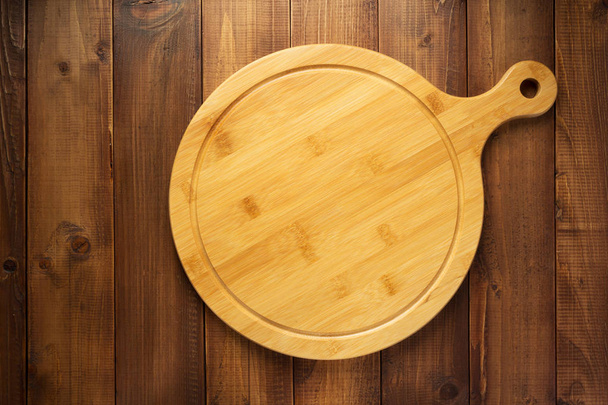 cutting board on wooden background table  - Foto, imagen