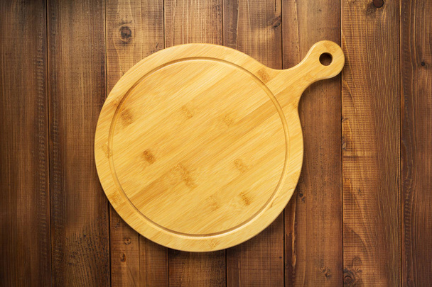 cutting board on wooden background table  - Zdjęcie, obraz
