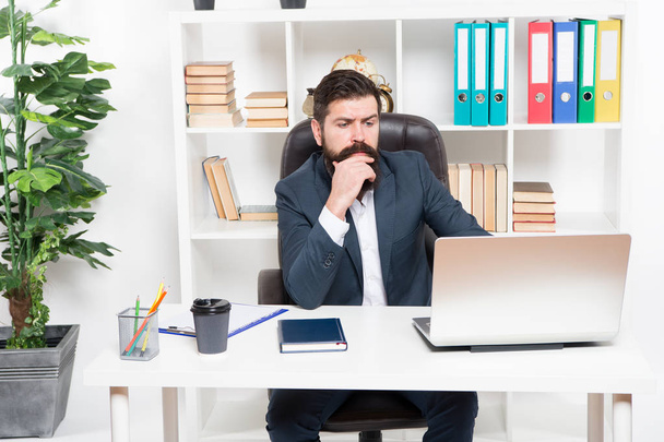 Broker tracks financial indicators. Man bearded hipster boss sit in leather armchair office interior. Boss at workplace. Manager formal corporate style working. Business people. Busy boss in office - Fotoğraf, Görsel