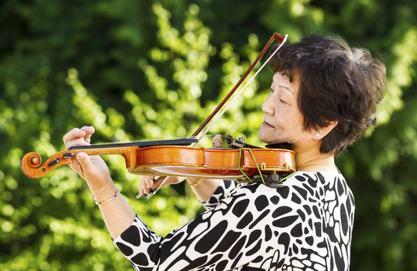 Senior woman performing music outdoors - Photo, Image