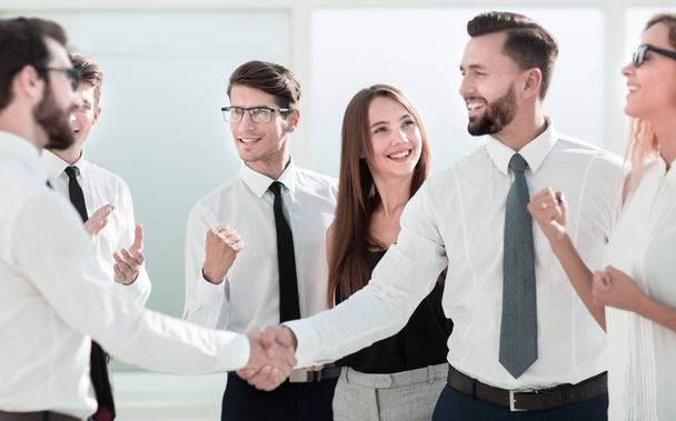 happy business team looking for a handshake of business partners - Фото, изображение