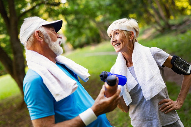 Beautiful sporty senior couple staying fit with running and jogging - Foto, Imagem