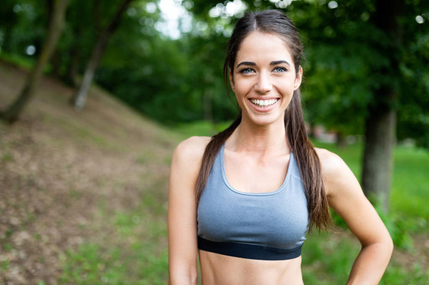 Portrait of athletic woman resting after jogging outdoor - Photo, Image