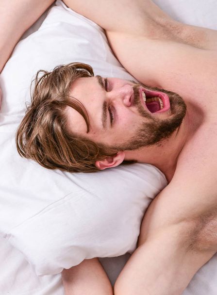 Get adequate and consistent amount of sleep every night. Expert tips on sleeping better. How much sleep you actually need. Bearded man sleeping face relaxing on pillow. Man handsome guy lay in bed - Photo, Image