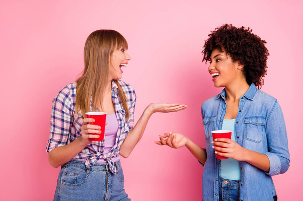 Portrait of two person nice sweet fascinating lovely attractive charming cheerful girls in casual checkered shirt communicating having fun rest relax isolated over pink pastel background - Foto, imagen