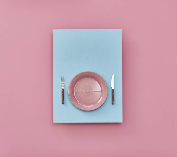 plate on table ,pink and blue background  - Photo, Image