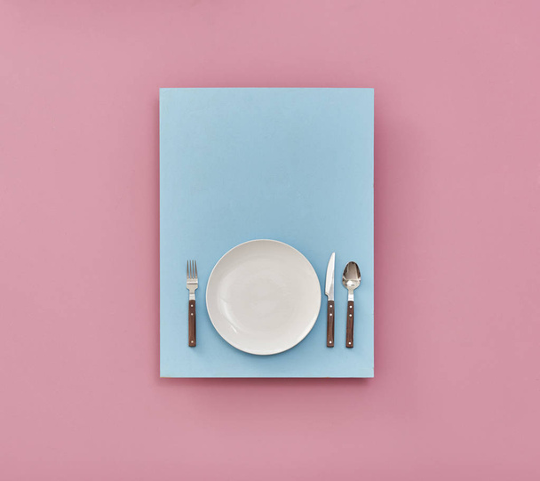 plate on table ,pink and blue background  - Фото, изображение