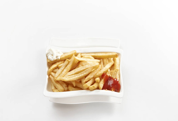 Fried potato with ketchup and mayonnaise. - Фото, зображення