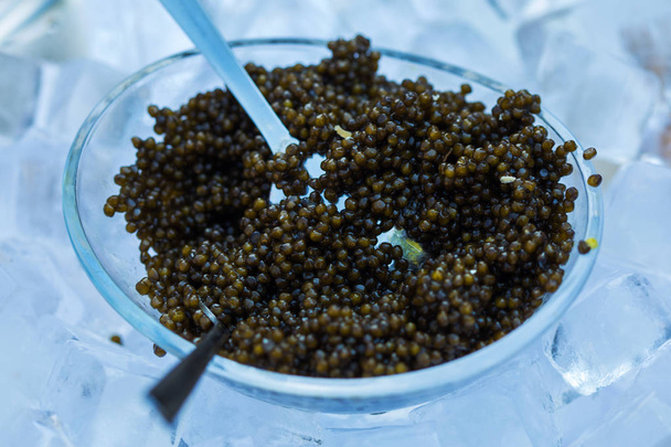 Metal spoon and black caviar closeup - Photo, Image
