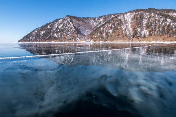 Baikal Range is reflected in the ice of Lake Baikal - Photo, image