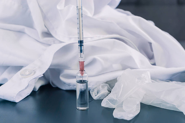 syringe with the drug near a white Bathrobe - Foto, Imagem
