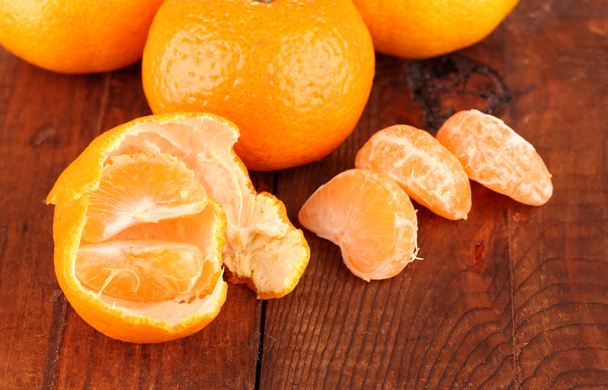 Tasty mandarines on wooden background - 写真・画像
