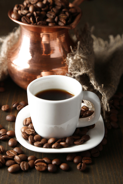Cup of coffee and pot on wooden background - Foto, Imagen