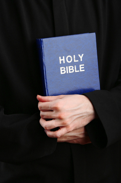 Priest holding holy bible, close up - Fotografie, Obrázek