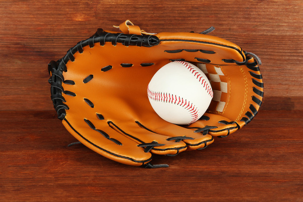 Baseball glove and ball on wooden background - Foto, imagen