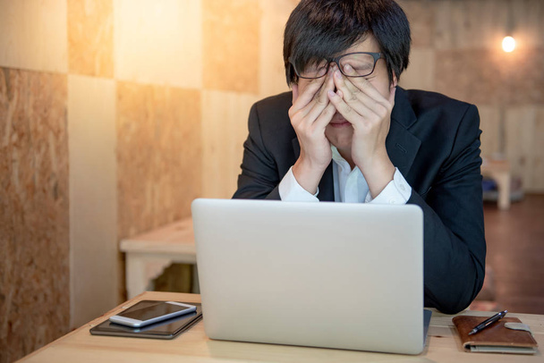 Overworked Asian businessman feeling stressed - Φωτογραφία, εικόνα
