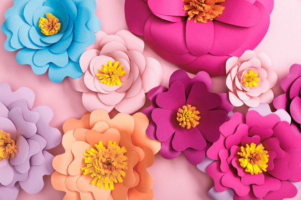 Widok z góry papieru kolorowych kwiatów na różowym tle  - Zdjęcie, obraz