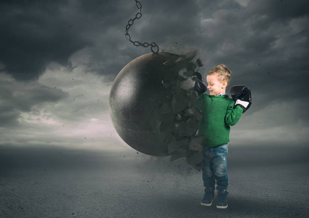Power and determination of a child against a wrecking ball - Photo, Image