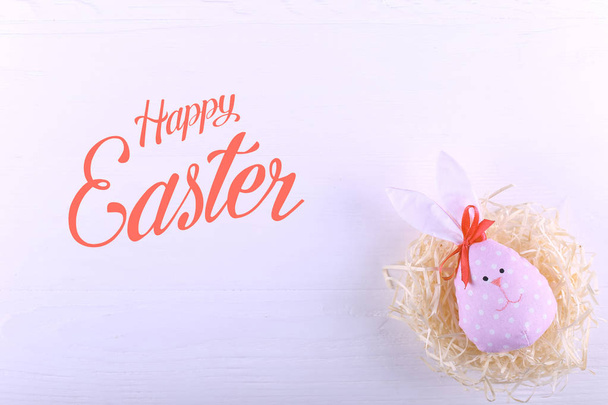 Pink hare in the nest, copy space. Happy Easter concept greeting card design. Text, happy easter. - Foto, immagini
