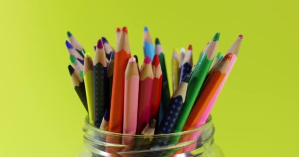 colored pencils in jar rotating on yellow background. seamless loop - Footage, Video