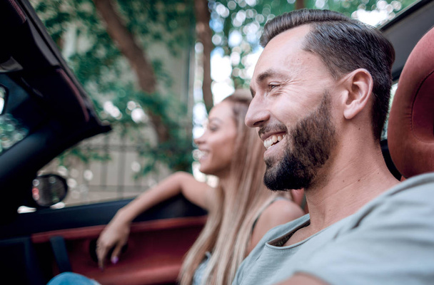 close up.smiling man driving a luxury car - Photo, Image