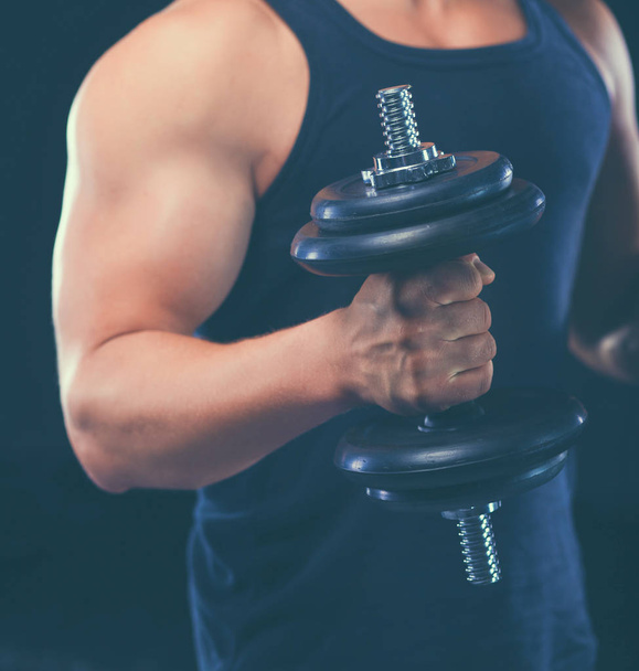 Handsome muscular man working out with dumbbells - Foto, Imagen