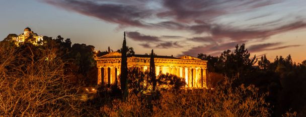 Athens Greece. Hephaestus temple and old national observatory, illuminated, at night - Photo, Image