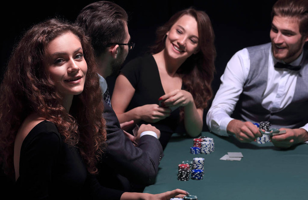 players sitting at the playing table in the casino - Foto, Imagen