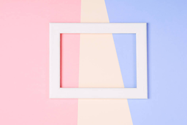 White wooden frame over pastel colorful paper background - Foto, Imagen