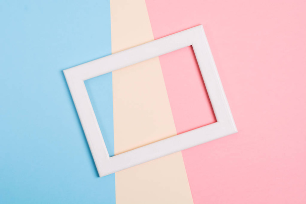 Colorful paper background with white wooden frame - Φωτογραφία, εικόνα