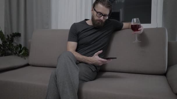 Handsome bearded man relaxing on sofa - Felvétel, videó