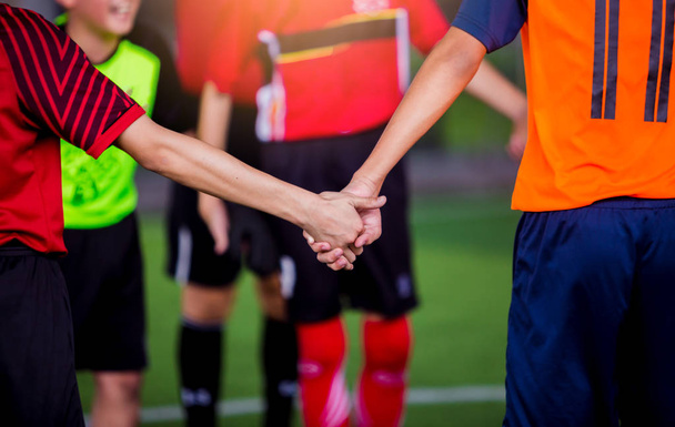 boy soccer players tap hands together for football training - Foto, Imagen