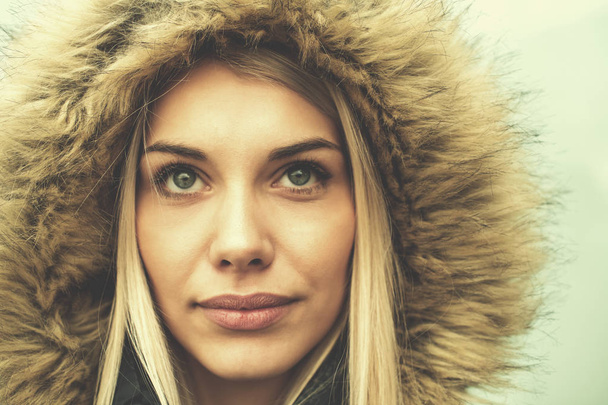portrait of young blonde girl wearing winter jacket - Фото, изображение