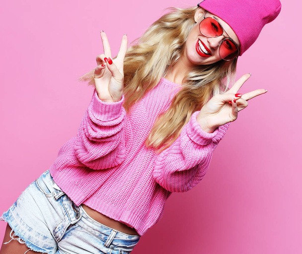 Cool cheerful girl with bright red lips wears modern knitted cap - Φωτογραφία, εικόνα