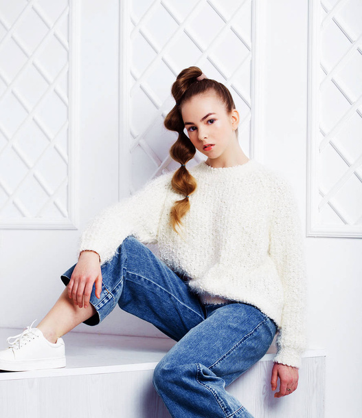 Fashion and people concept: stylish teen girl in casual clothes sitting on stairs and posing - Photo, Image