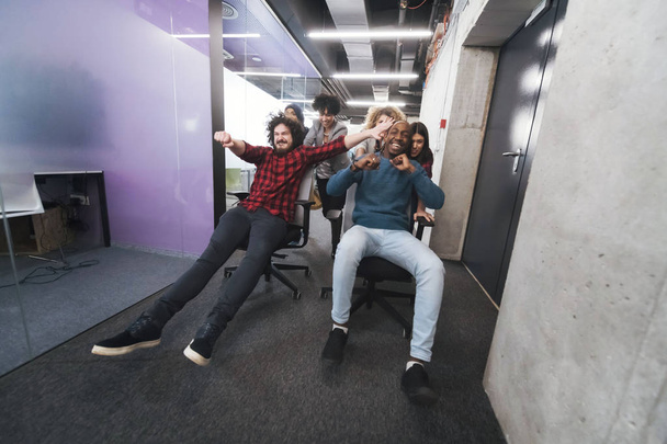 multiethnics business team racing on office chairs - Foto, Imagem