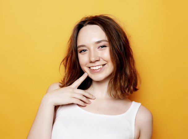 Portrait of young positive female with cheerful expression - Foto, afbeelding