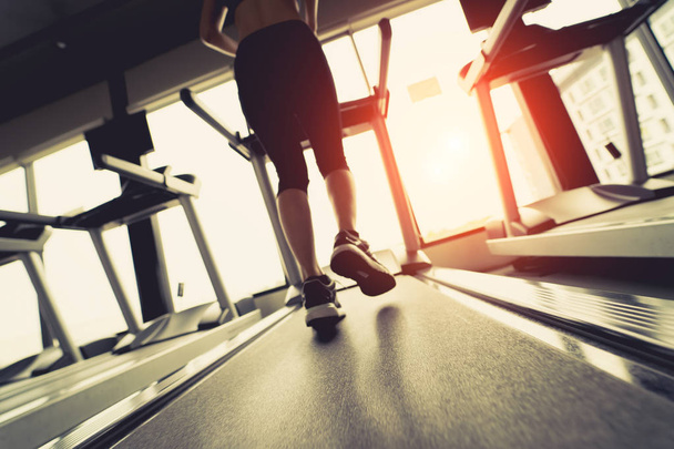 Exercise treadmill cardio running workout at fitness gym of woman taking weight loss with machine aerobic for slim and firm healthy in the morning Soft focus. - Foto, Imagem