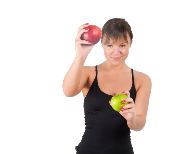beautiful young sport woman with red and green apple, isolated on white - 写真・画像