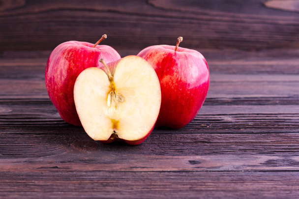 Красные яблоки на деревянном столе. - Фото, изображение