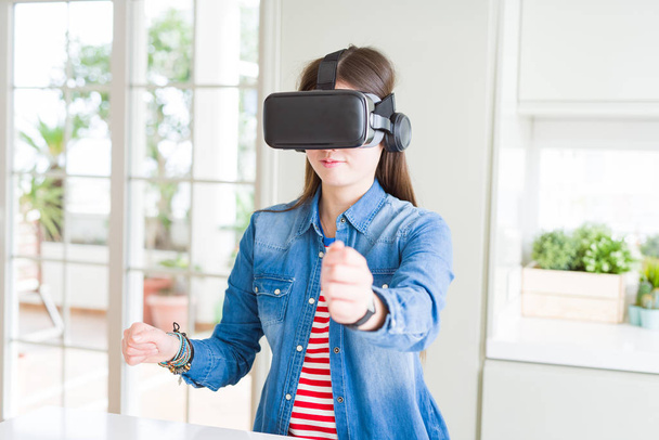 Young asian woman wearing virtual reality glasses smiling and co - Photo, Image