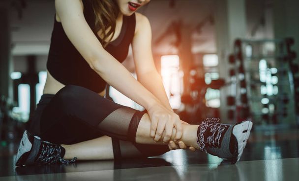 Woman doing sport exercise injury leg accident at gym fitness  - Fotó, kép