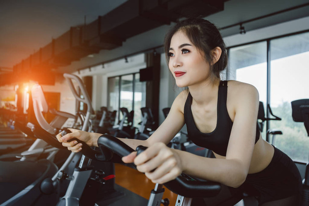 Young asian woman exercise cardio workout on treadmill machine and healthy lifestyle bodybuilding at fitness gym. - Fotografie, Obrázek