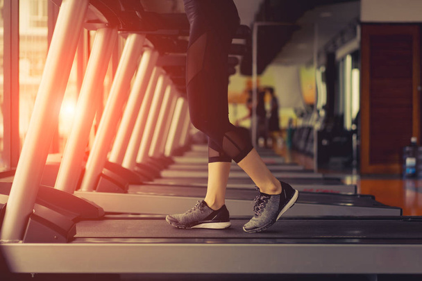 Exercise treadmill cardio running workout at fitness gym of woman taking weight loss with machine aerobic for slim and firm healthy lifestyle in the morning. - Foto, Imagem