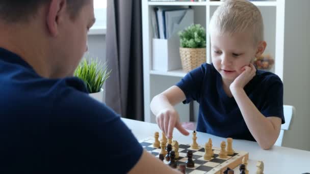 Little boy playing chess with his father. Education and family concept - Filmmaterial, Video
